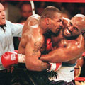 Mike Tyson bites Evander Holyfield's ear.