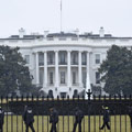 A man climbs over the gates of the White House.