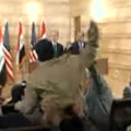 An Iraqi journalist throws his shoes at President Bush.